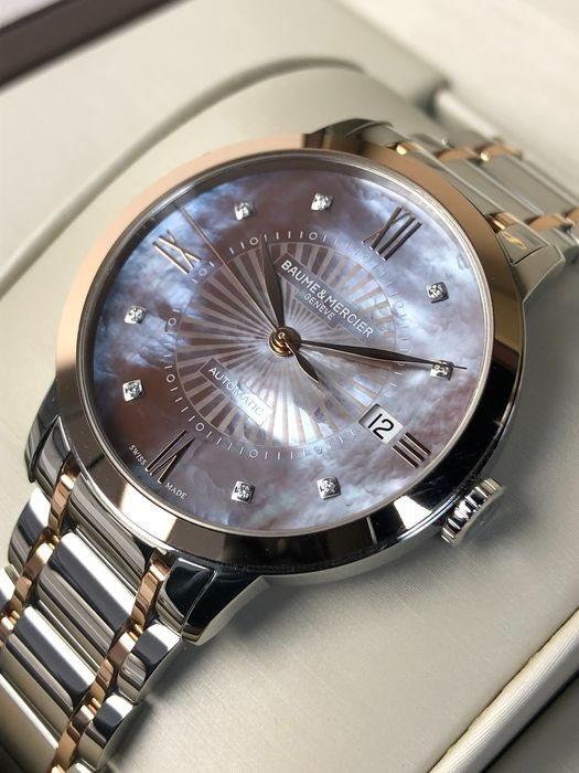 10297 שעון יוקרה של באום מרסייה לאישה 18K | דגם אוטומטי משובץ 8 יהלומים בלוח פנינה חום/אפור מיוחד | רצועה ובאזל מזהב 18K מלאי מוגבל | שנתיים אחריות Baume & Mercier Classima Automatic 36mm MOA10297