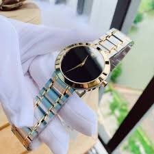 0607278 שעון מובאדו אלגנטי קלאסי לגבר | דגם משולב זהב לוח שחור נקי ומיוחד | שעון שווצרי יוקרתי דק | שנתיים אחריות | Movado Stiri Two-Tone Mens Watch 0607278