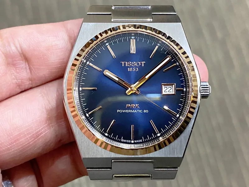 T931.407.41.041.00 שעון טיסו מיוחד לגברים | באזל זהב 18K בלוח כחול מיוחד | מנגנון אוטומטי 80 שעות | מלאי מוגבל | 3 שנים אחריות | Tissot PRX Powermatic 80 Steel & 18K Gold Bezel T9314074104100