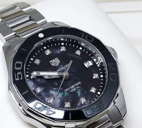 WAY131M.BA0748 שעון טאג הויאר לנשים משובץ 11 יהלומים לוח שחור פנינה | דגם 300 מטר מסדרת אקווה רייסר | שנתיים אחריות | TAG Heuer Aquaracer Lady Black/Steel ?35 mm,model WAY131M.BA0748