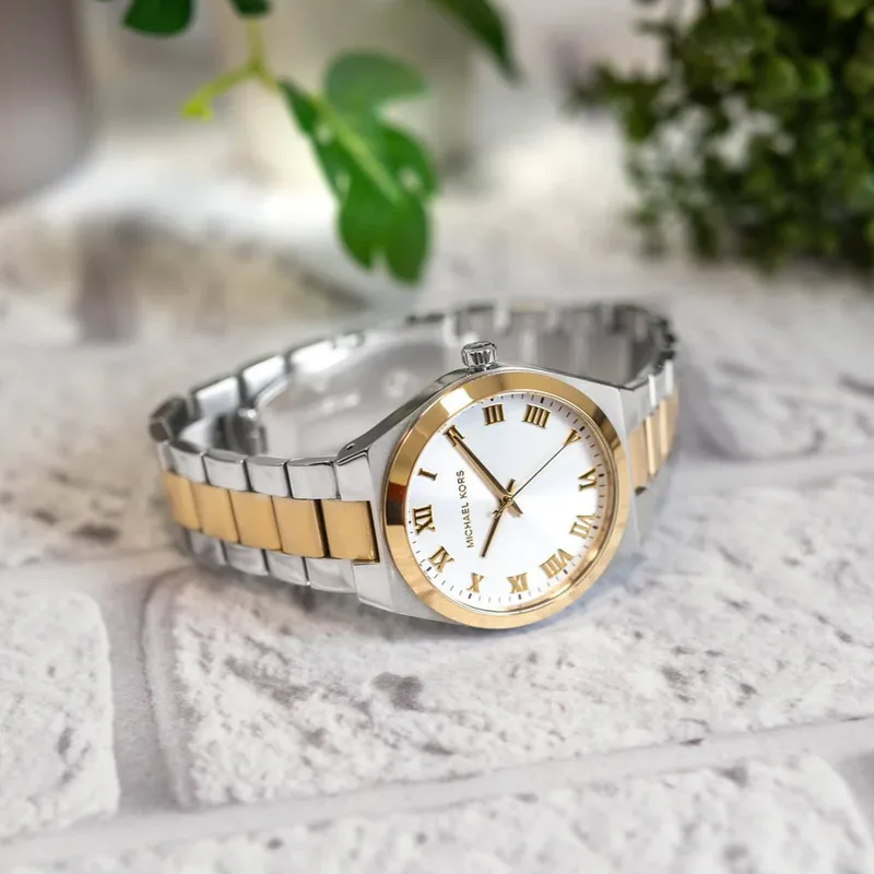 MK7464 שעון מייקל קורס יבואן רשמי לנשים | דגם משולב זהב | לוח רומי לבן קלאסי ואלגנטי | מלאי מוגבל | כולל שנתיים אחריות פלאנט |Michael Kors Lennox Steel Bracelet White Dial Women';s Watch MK7464