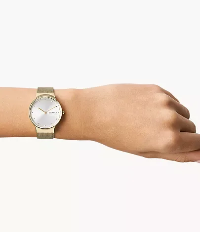 SKW3027 שעון סקאגן זהב לאישה | דגם ברצועת רשת אופנתית | לוח כסוף משובץ זרקונים | שעון יד עם שנתיים אחריות יבואן רשמי | NEW Skagen Women';s Freja Quartz Watch w MESH Stainless Steel Strap Gold SKW3027